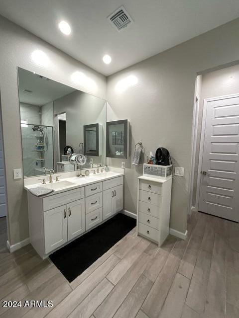 bathroom with walk in shower and vanity