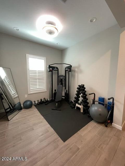 workout area with light wood-type flooring