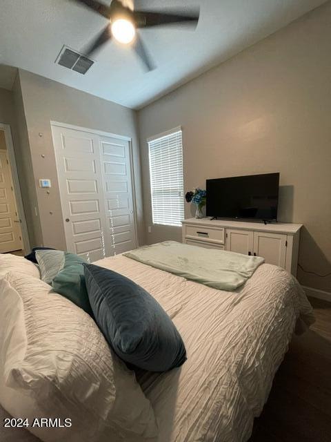 bedroom with ceiling fan and a closet