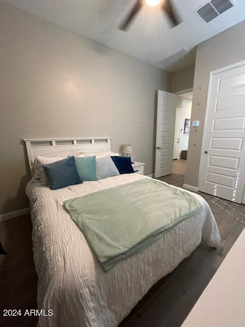 bedroom with ceiling fan and dark hardwood / wood-style floors