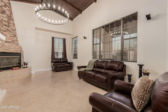 tiled living room featuring a stone fireplace, an inviting chandelier, wood ceiling, and high vaulted ceiling