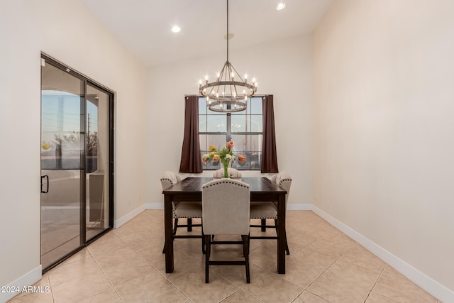 dining area featuring vaulted ceiling, light tile patterned floors, and a chandelier