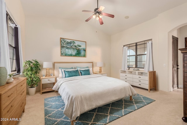 carpeted bedroom featuring lofted ceiling and ceiling fan