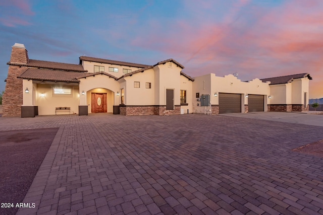 mediterranean / spanish home with a garage