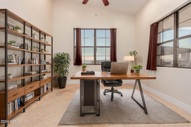 tiled office space with vaulted ceiling and ceiling fan