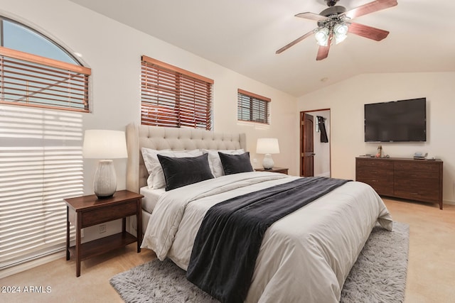 carpeted bedroom featuring vaulted ceiling and ceiling fan