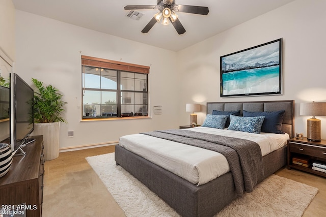 bedroom featuring light carpet and ceiling fan