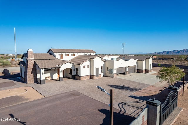 view of front facade featuring a mountain view and a patio area