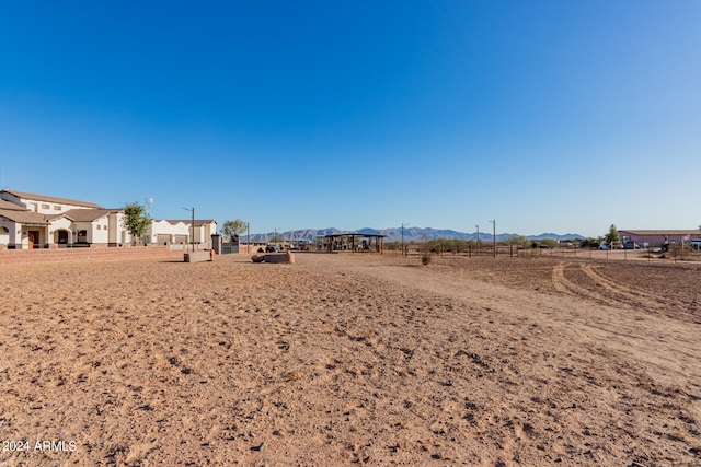 view of yard with a rural view and a mountain view