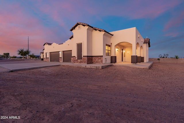 view of back house at dusk