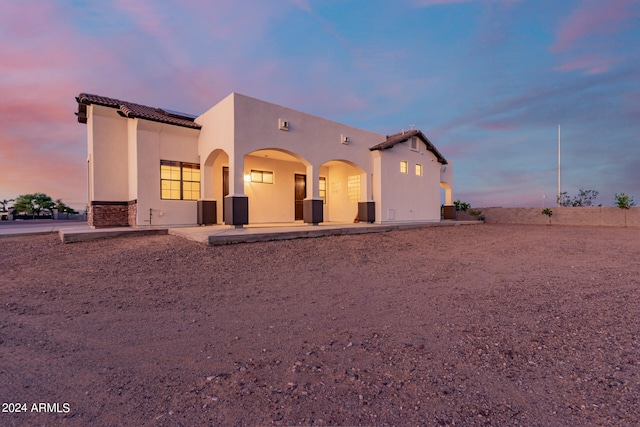 view of back house at dusk