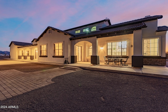 mediterranean / spanish-style home with a patio