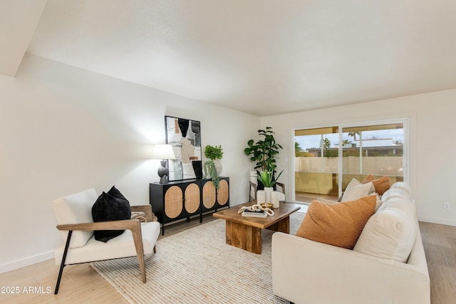 living room featuring light wood-style flooring and baseboards