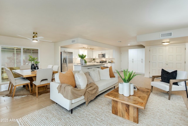 living room featuring visible vents and light wood-style floors