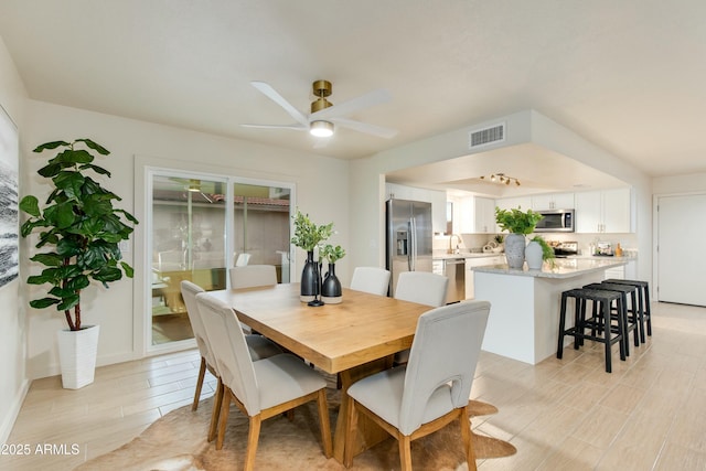 dining room featuring a ceiling fan and visible vents