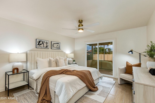 bedroom with light wood-style flooring, baseboards, ceiling fan, and access to outside