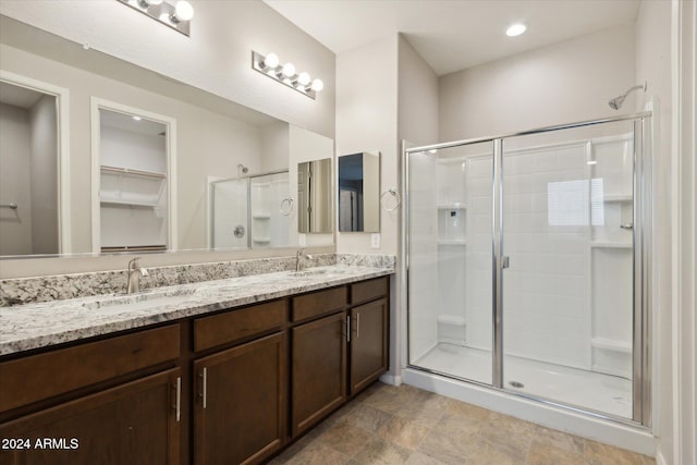 bathroom featuring vanity and an enclosed shower