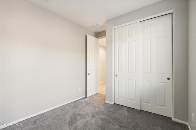 unfurnished bedroom featuring a closet and carpet