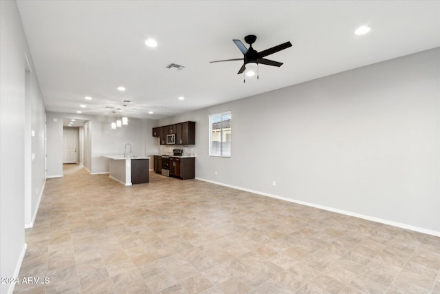 unfurnished living room with sink and ceiling fan