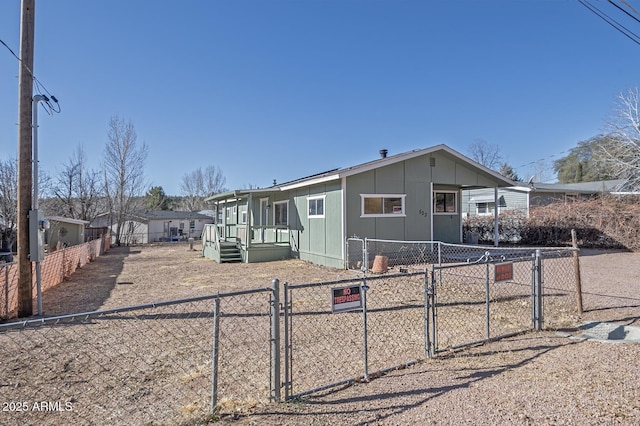 manufactured / mobile home featuring a gate and fence