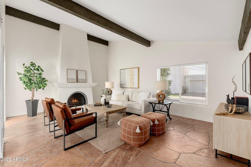 living room featuring vaulted ceiling with beams and a large fireplace