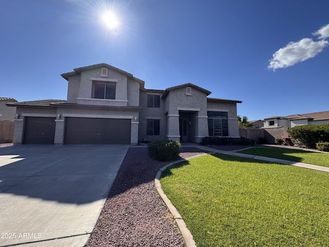 view of front facade with a front lawn, fence, stucco siding, an attached garage, and driveway