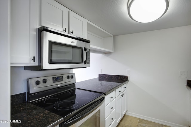 3619 E Monterosa St Unit 202, Phoenix, AZ 85018 - kitchen featuring stainless steel appliances, white cabinets, dark stone countertops, and open shelves