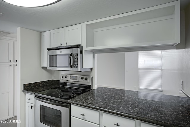 3619 E Monterosa St Unit 202, Phoenix, AZ 85018 - kitchen featuring stainless steel appliances, white cabinets, and dark stone countertops