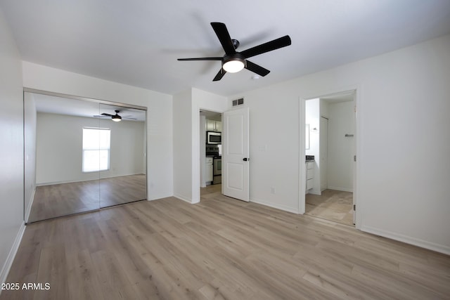 3619 E Monterosa St Unit 202, Phoenix, AZ 85018 - unfurnished bedroom featuring light wood finished floors, a closet, a ceiling fan, and ensuite bathroom