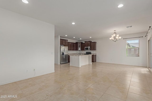 unfurnished living room with an inviting chandelier and sink