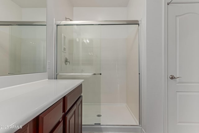 bathroom featuring an enclosed shower and vanity