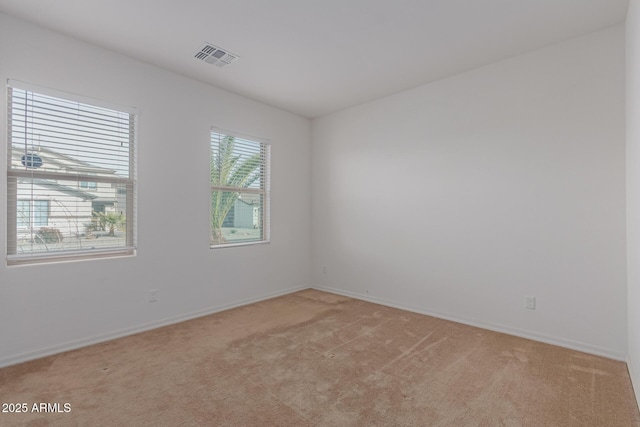 unfurnished room featuring light colored carpet