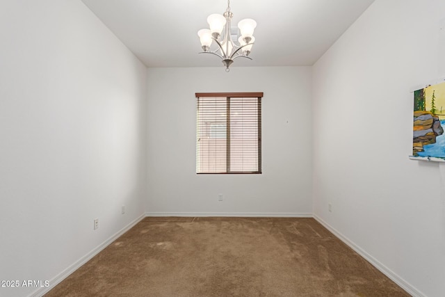 spare room featuring a notable chandelier and carpet flooring