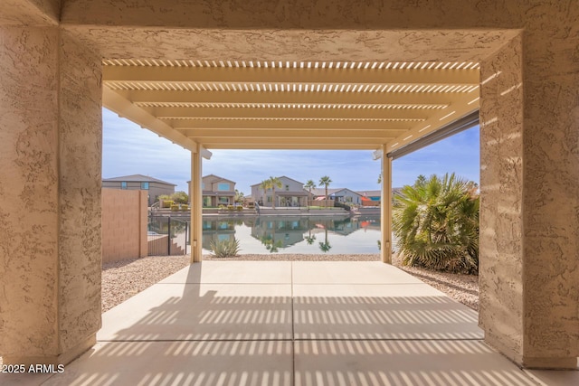 view of patio featuring a water view and a pergola