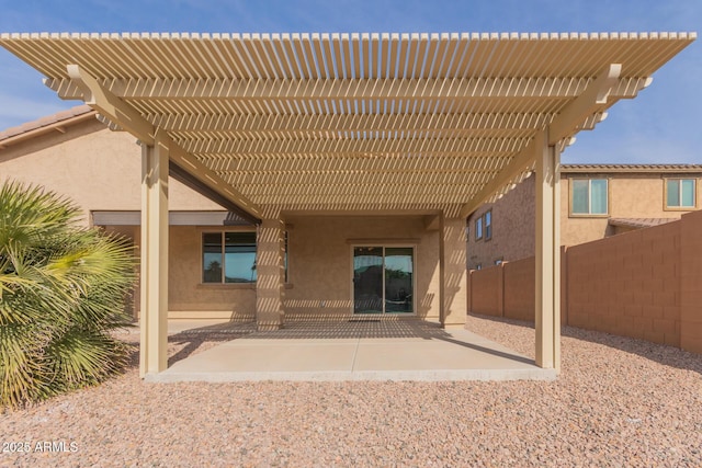 back of property featuring a pergola and a patio area