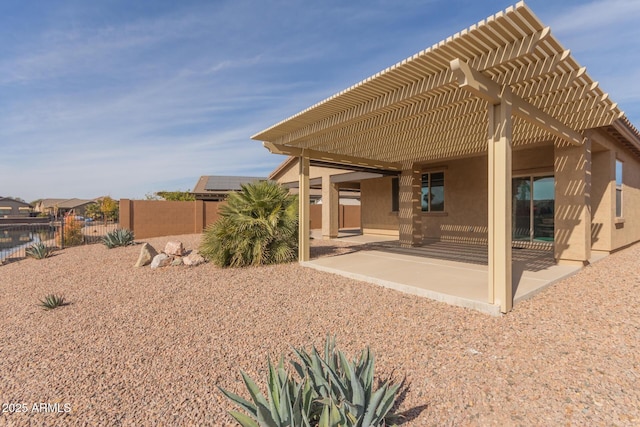 back of house with a pergola and a patio area