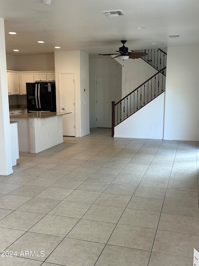 unfurnished living room featuring ceiling fan, light tile patterned floors, recessed lighting, visible vents, and stairs