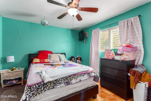 tiled bedroom with ceiling fan