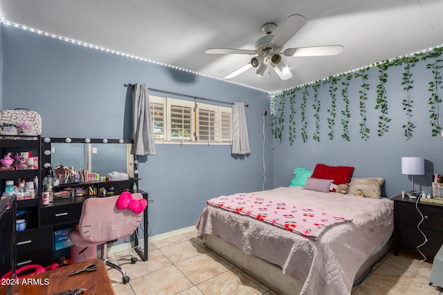 bedroom with ceiling fan and light tile patterned flooring