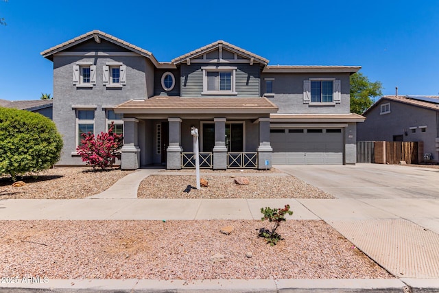 craftsman-style home featuring a garage, stucco siding, a porch, driveway, and a tile roof