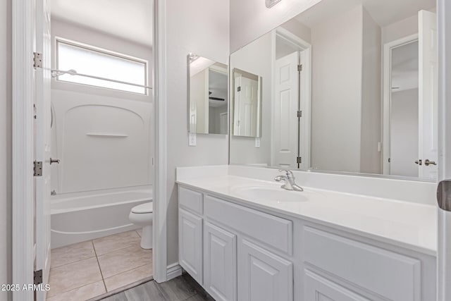bathroom with shower / bath combination, vanity, and toilet