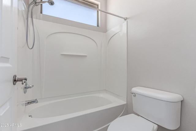 bathroom featuring bathtub / shower combination and toilet
