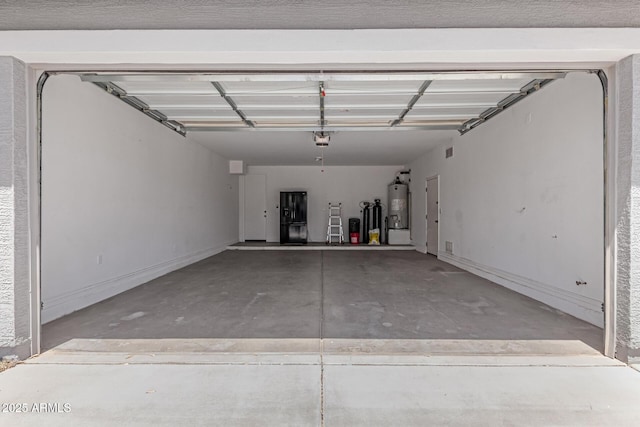 garage with a garage door opener and gas water heater