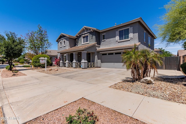 craftsman house featuring an attached garage, stucco siding, a porch, a tiled roof, and driveway