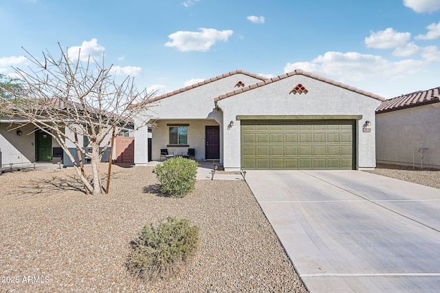 mediterranean / spanish house featuring a tile roof, driveway, an attached garage, and stucco siding