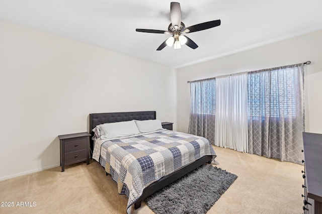 bedroom featuring ceiling fan, baseboards, and light colored carpet