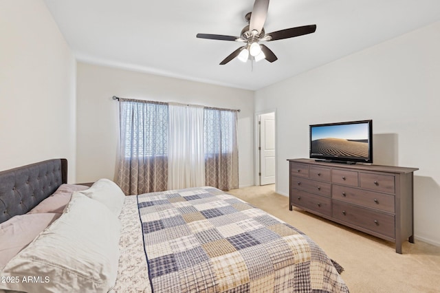 bedroom with a ceiling fan and light colored carpet