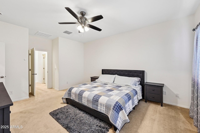 bedroom with light colored carpet, visible vents, and baseboards