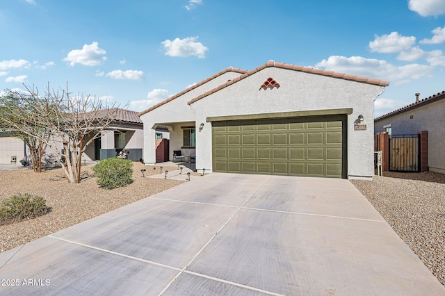 mediterranean / spanish-style house featuring a garage, a tile roof, driveway, and stucco siding