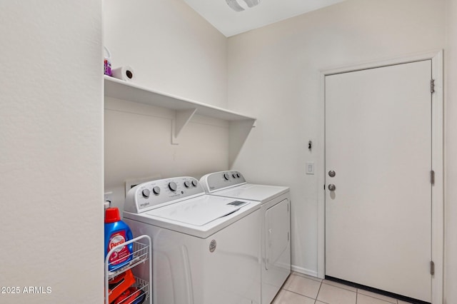 washroom featuring light tile patterned floors, laundry area, and washing machine and clothes dryer